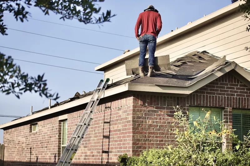 Professional roofer working on a residential roof in Marlboro